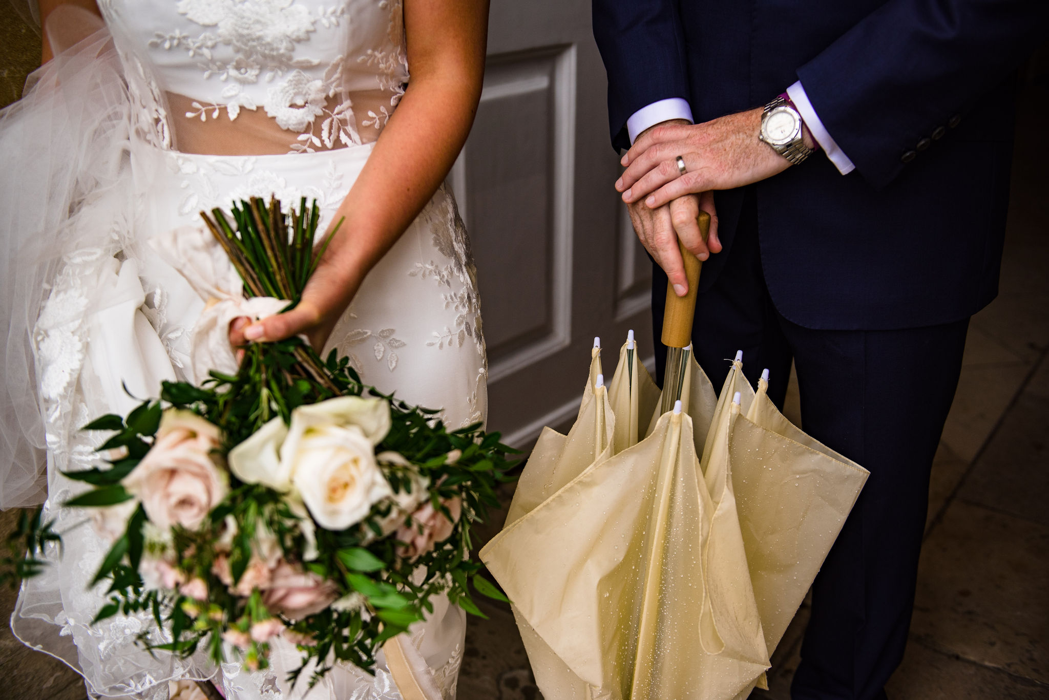 Bride with bouquet and groom with umbrella